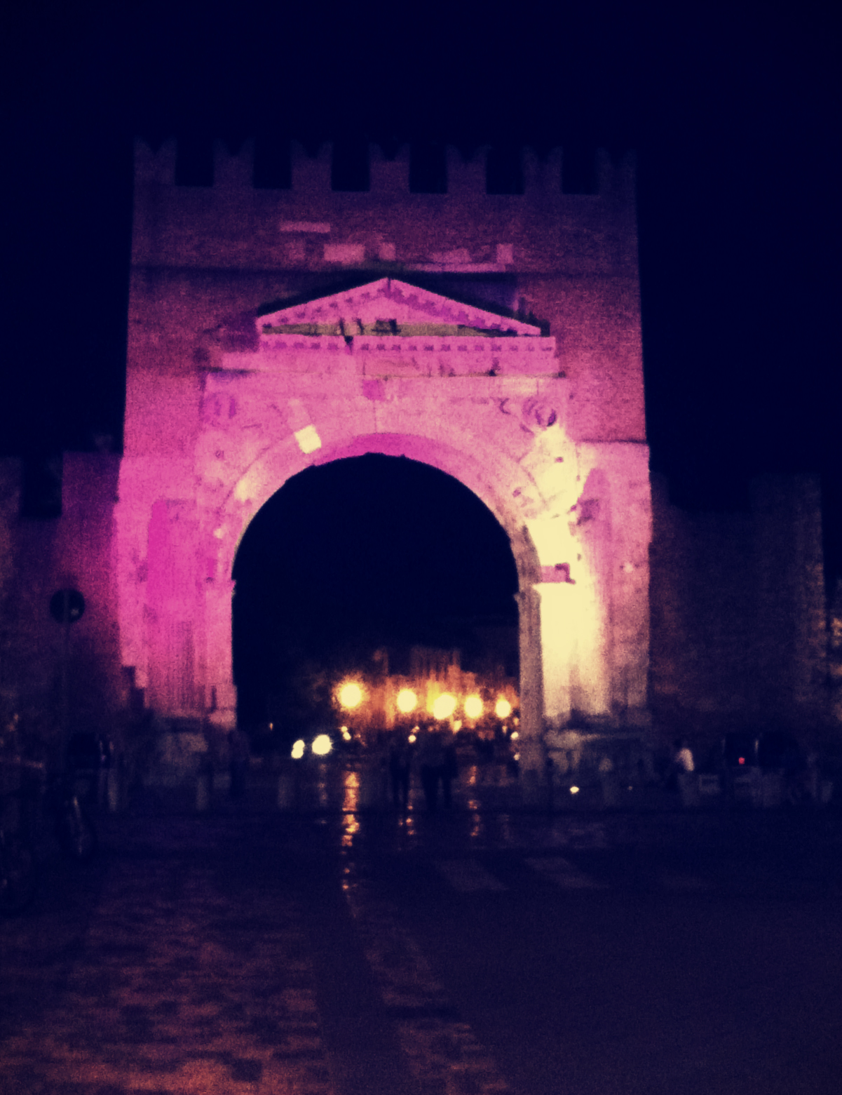 The Arco d'Augosto lit up in preparation for the Notte Rosa
